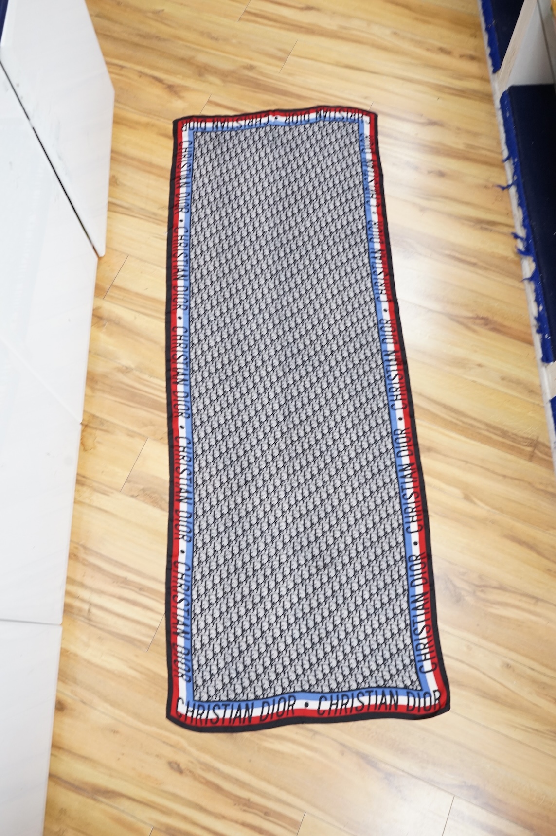 Three silk scarves comprising a Burberry check example, Christian Dior monogrammed and a Vakko abstract patterned example